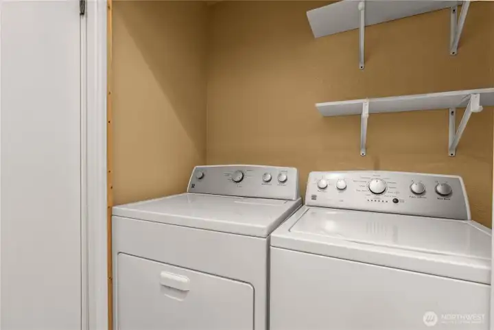 Side-by-side washer and dryer located within the powder room for added convenience