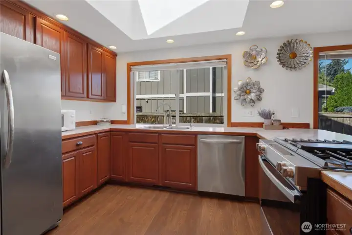Plenty of room for meal prep in bright and light kitchen w/ ss appliances & gas range w/down vent