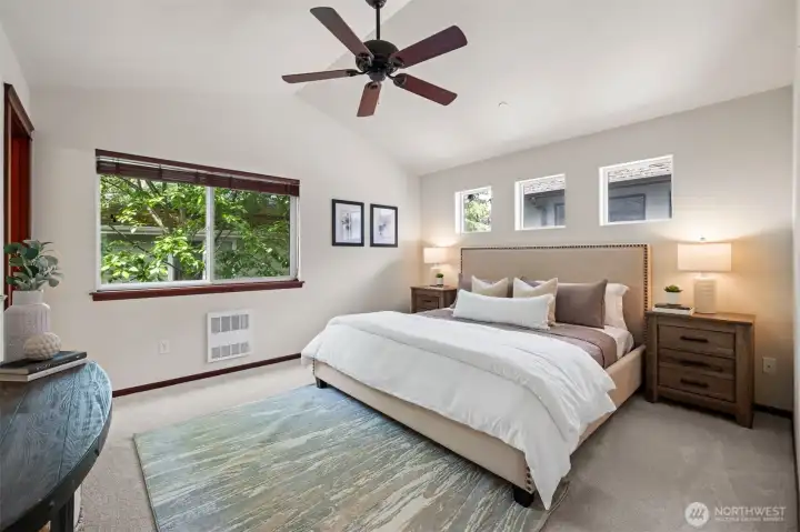 Primary suite with vaulted ceilings and a ceiling fan for a cool breeze.