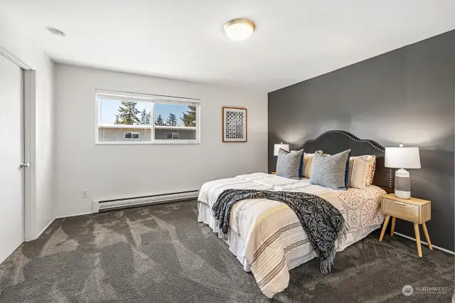 The bedroom is huge, with plenty of space for all the necessary furniture. It has a western view and features two closets - a walk-in through this door, and a large reach-in closet just out of view.