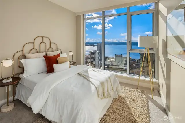 The second bedroom enjoys western views to the water and a large closet with built-ins by CA Closet.