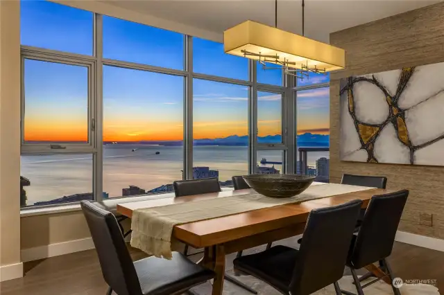 Floor-to-ceiling windows showcase dazzling sunsets.