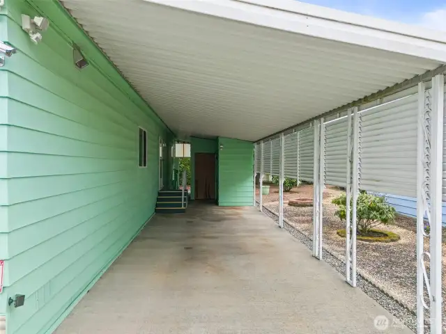 Covered carport with a storage area.