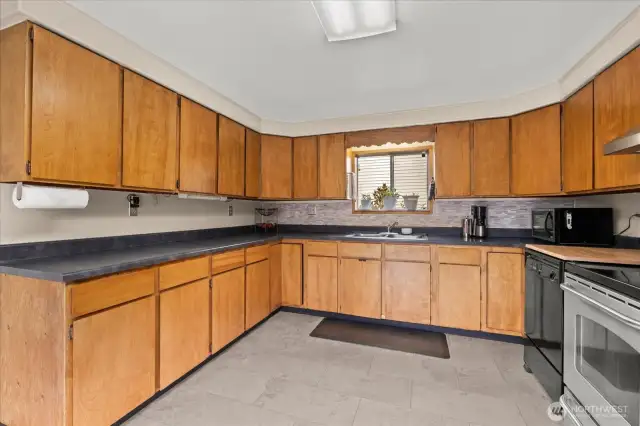 New tile floors in kitchen with plenty of cupboard space.