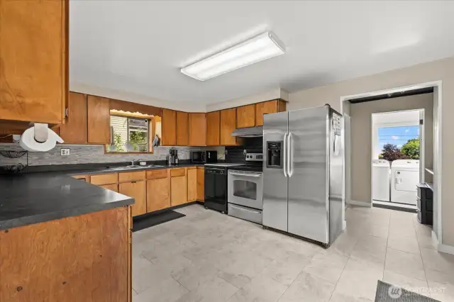 New tile kitchen leading to bathroom/ utility area.