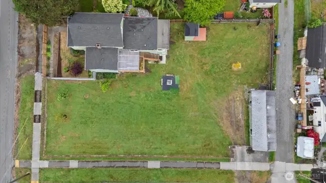 Aerial view shows the massive yard on a corner lot.  Do you have pets or want to build?