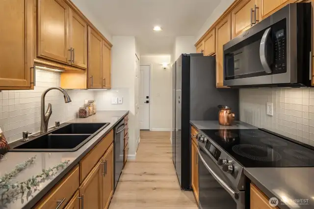 Gorgeous kitchen with stainless steel appliances, quartz counters and custom-built cabinets