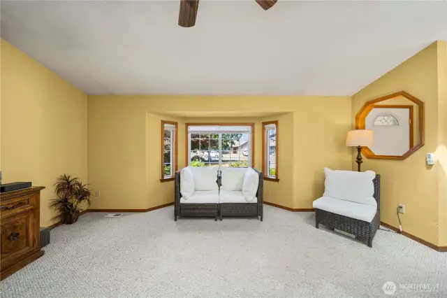 Living room facing the lovely bay window showcasing the front yard.
