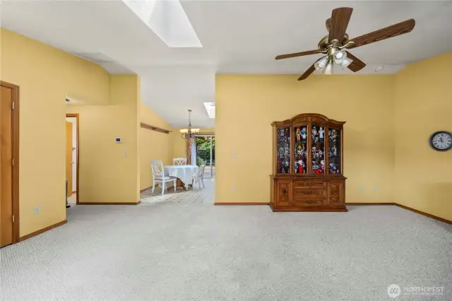Living room showing coat closet to the left, dining area straight ahead and the hallway leading to the 3 bedrooms and 2 bathrooms shown on the left.