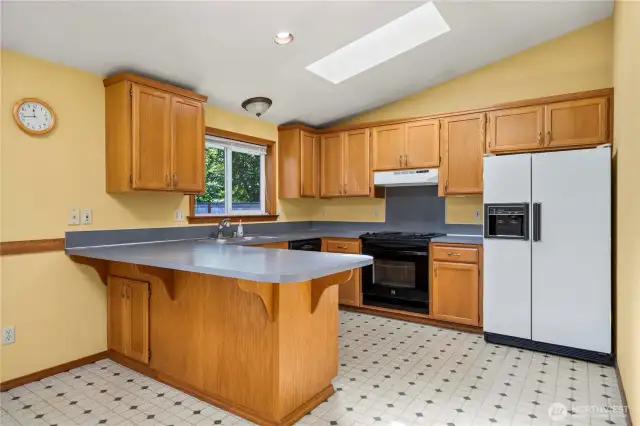 This efficient kitchen has plenty of room to prepare meals and offers a skylight for additional natural light.