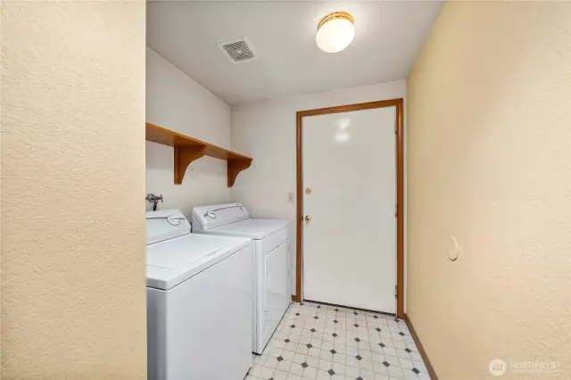 Laundry room with the entrance to the garage shown here.