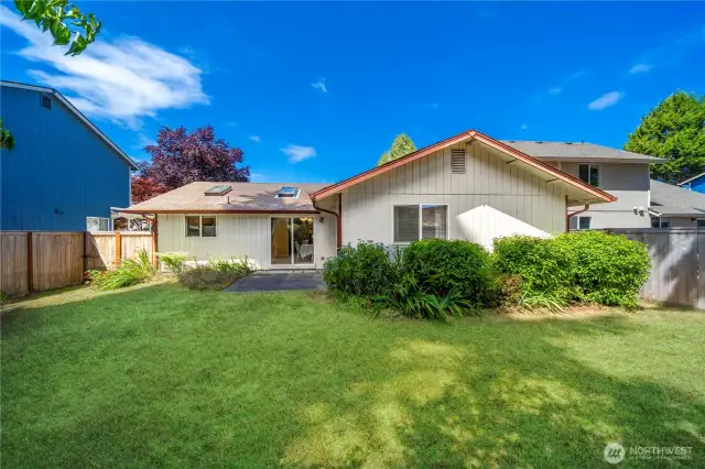 Large backyard fully fenced, with plenty of room for gardening or other activities.