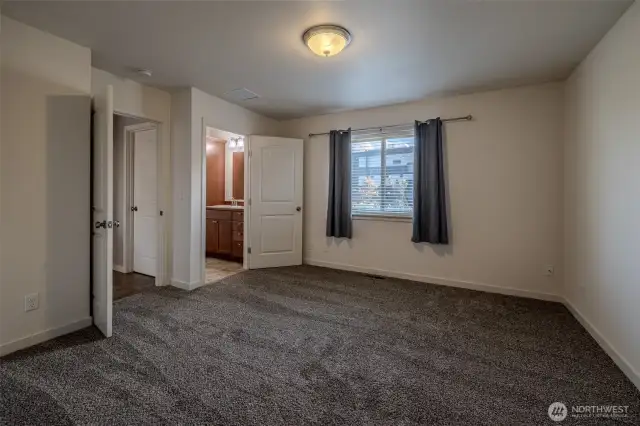 Primary bedroom connected to bathroom suite