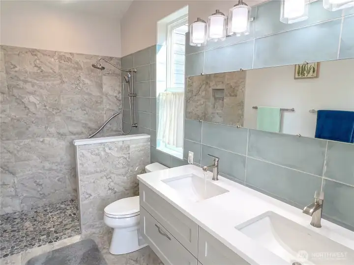 Beautifully tiled primary bathroom.