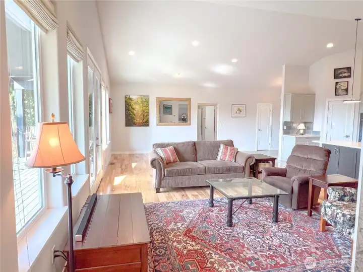 The ample space behind the couch for your dining table. Opening to the hallway for the main bath and two other bathrooms. Door to the right is the handy front closet.