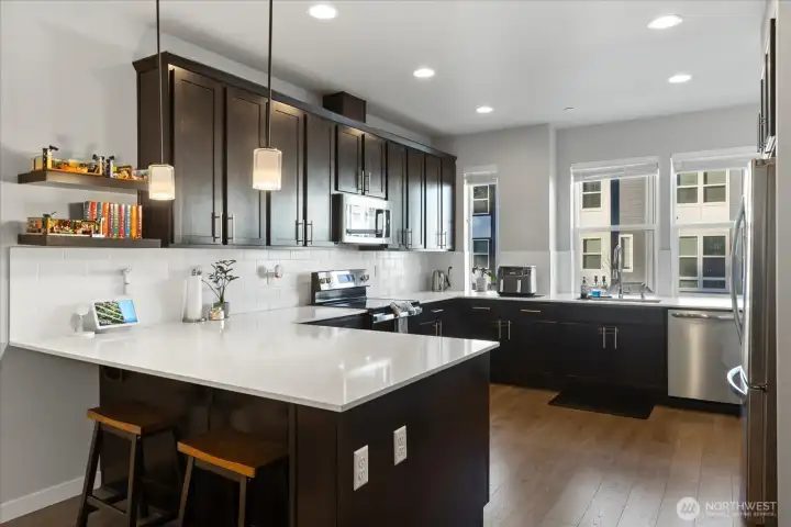 Beautiful chef's kitchen with qaurtz counters, SS appliances, walk-in pantry & ample cabinetry.