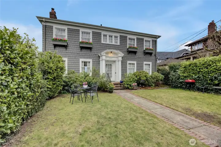 Lovely 1919 Colonial charmer.  Fully fenced.  Huge back garden/yard leading to 2-car garage on alley.