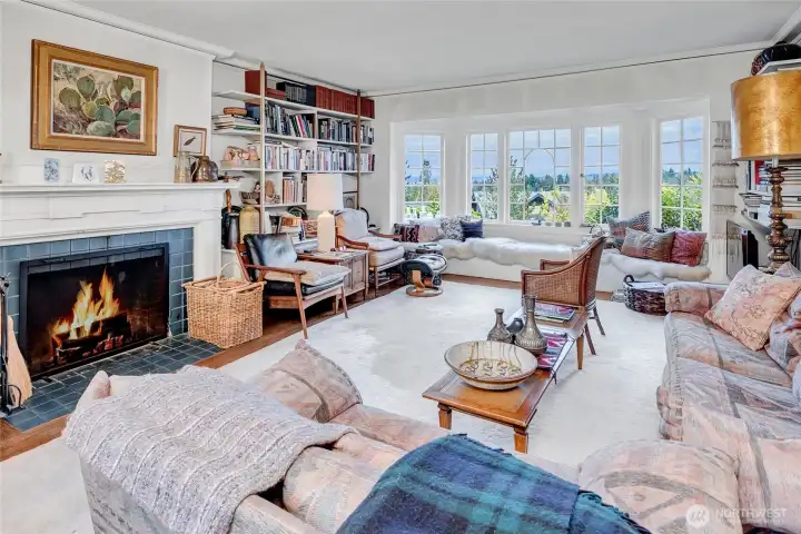 Lovely living room. Expanded window seating. Wood burning fireplace. Wonderful views of Lake WA & Cascade Mt. range to the East.