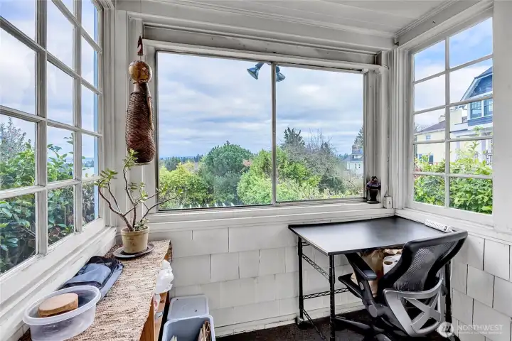 Little sunroom off of kitchen overlooking back garden & gazebo.