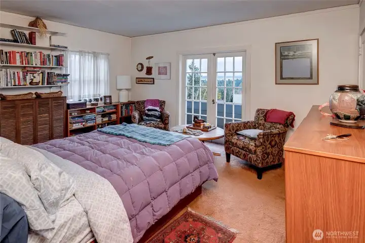 Primary bedroom with large walk-in closed.  French Doors open to patio looking to the Lake & Cascades.