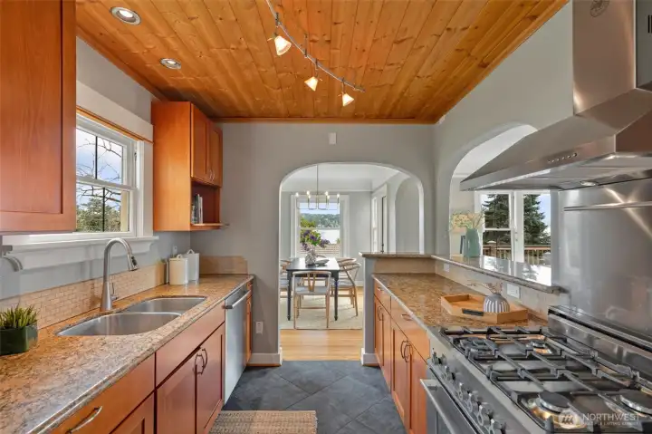 Light, bright kitchen with loads of cabinet space, Bertazzoni stove and tile floor leads directly to dining area - and has outlook to living room and views