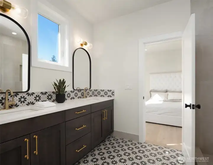 Bathroom with double sinks and shower on upper level