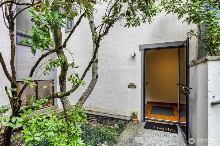 Welcome home! Sweet little courtyard entrance with beautiful landscaping.