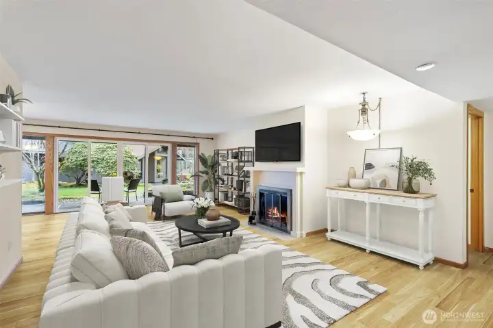 Extra large living and dining room with a wall of windows and brand new, wide plank  luxury vinyl plank floors. Floors are darker than shown in photos.