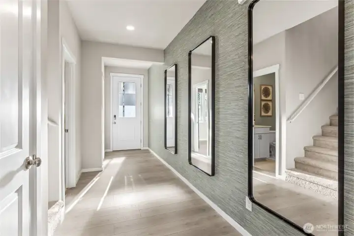 Bright and wide interior hallway with 8' front door. Photos are representative only and may display different color package and/or upgrades.