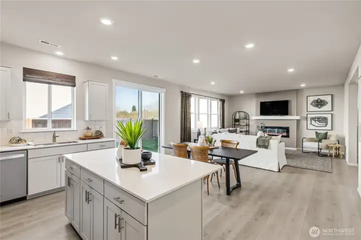 Gourmet kitchen featuring a large center island for those that love to cook and bake. Quartz countertops, and an open view to the great room, dining area, and fireplace. Photos are representative only and may display different color package and/or upgrades.