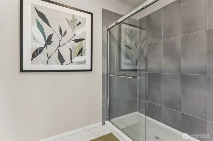 Elegant walk-in shower in the primary ensuite featuring glass enclosure and modern fixtures. Photos are representative only and may display different color package and/or upgrades.