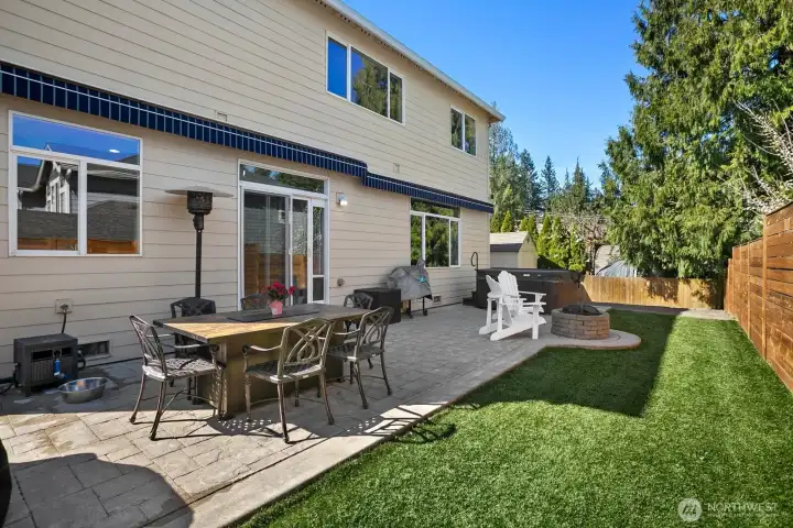 Backyard showing 2 separate awnings pulled back (remote control or manual) to allow full sunlight.