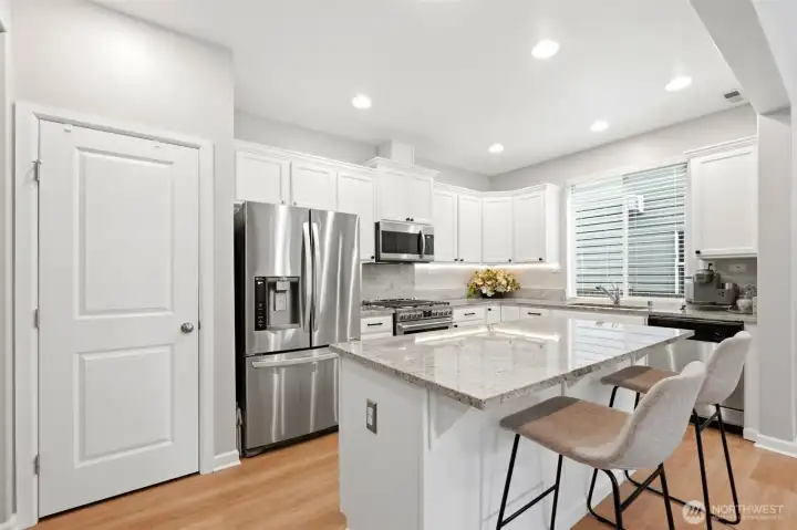 Spacious kitchen with slab granite countertops. Spacious kitchen with slab granite countertops.