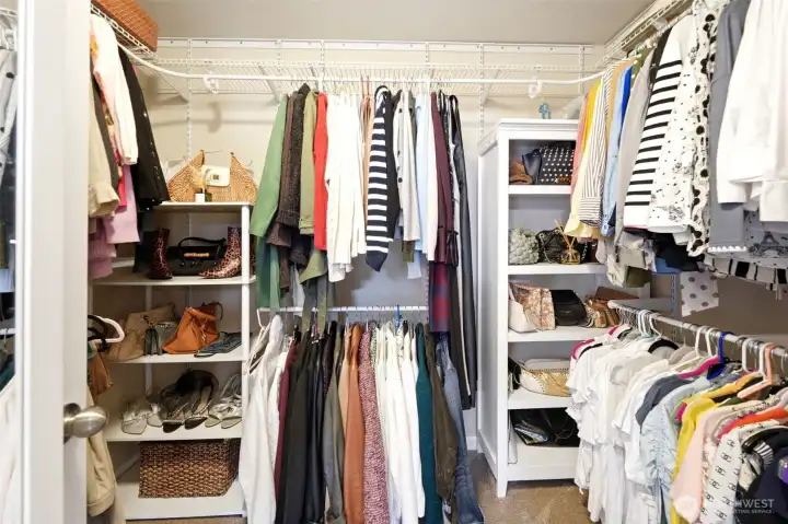 Walk-in closet in primary suite. Walk-in closet in primary suite.