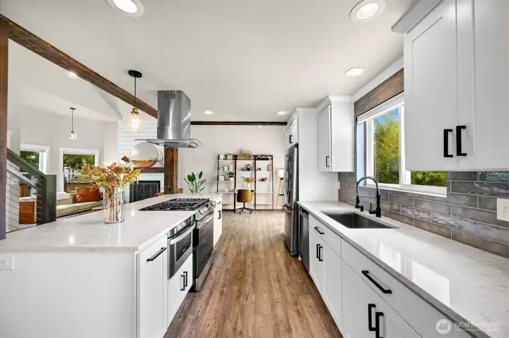 The spacious island with gas range creates a natural gathering space for cooking, entertaining, and casual dining while keeping you connected to the rest of the home.