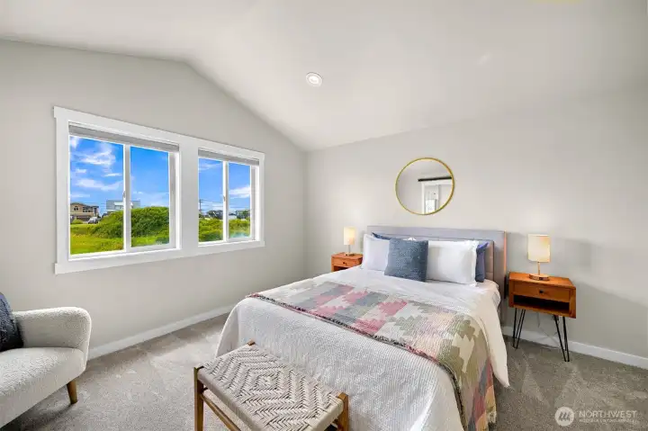Wake up to open views and enjoy a comfortable owner's retreat with ample space for a king-sized bed and additional seating.