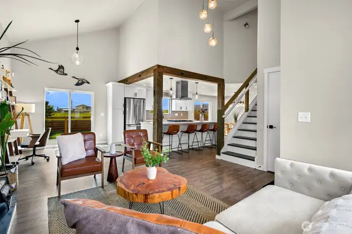 A versatile area adjacent to the great room offers space for a home office, reading nook, music room, or additional sitting area with direct access to the deck.