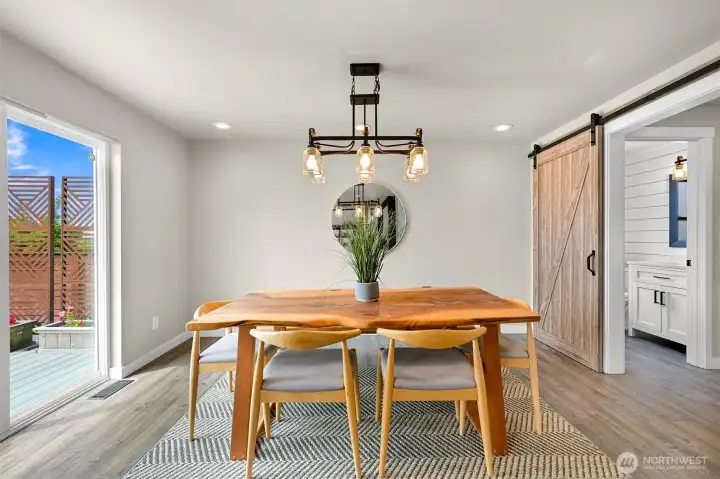 A dedicated dining space offers room for everyday meals, holiday gatherings, or dinner parties, complete with a statement light fixture and convenient access to the adjacent living areas.