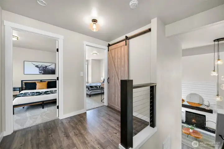 The upper level provides convenient access to the bedrooms while overlooking the bright, open living area below.