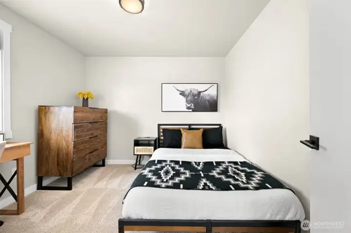 A versatile secondary bedroom offers space for guests, a home office, or hobbies, with natural light and room for a desk or additional furnishings.