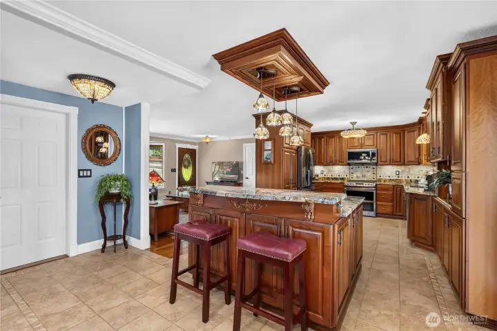 “View from the dining room looking into the kitchen; the door on the left leads to the garage.” “View from the dining room looking into the kitchen; the door on the left leads to the garage.”