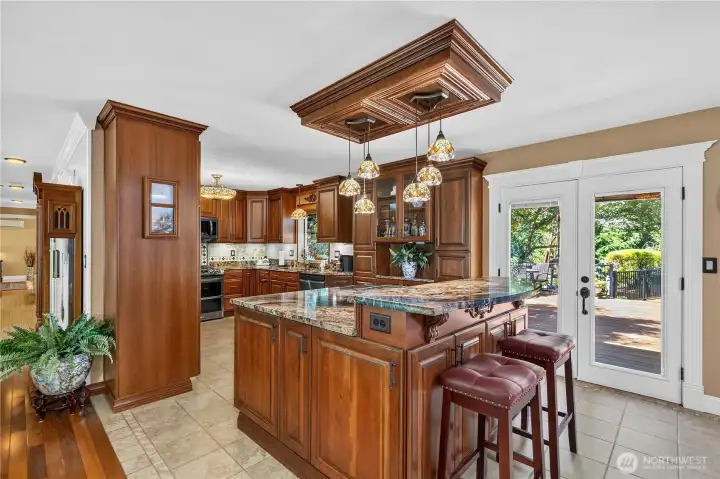 “View from the garage entry looking into the kitchen; French doors open to a 900-square-foot bamboo deck.” “View from the garage entry looking into the kitchen; French doors open to a 900-square-foot bamboo deck.”