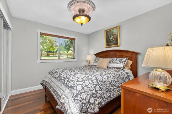 “Bedroom featuring designer lighting, Levolor wood blinds, and mirrored closet doors.” “Bedroom featuring designer lighting, Levolor wood blinds, and mirrored closet doors.”