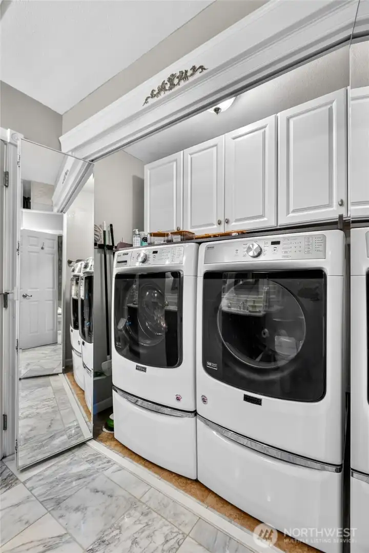 “Laundry area with ample storage space.” “Laundry area with ample storage space.”