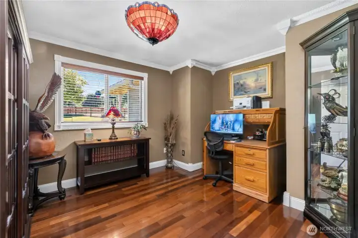 “Bedroom featuring crown molding, Tiffany lighting, and wood-wrapped windows." “Bedroom featuring crown molding, Tiffany lighting, and wood-wrapped windows."