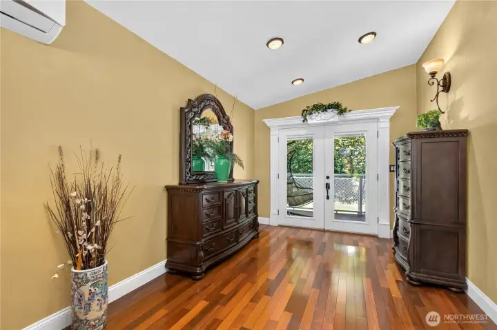 “Primary suite features French doors and custom trim, with access to a private rear deck.” “Primary suite features French doors and custom trim, with access to a private rear deck.”