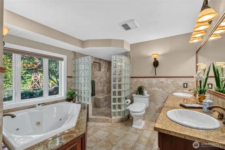 Primary bathroom featuring a spacious walk-in shower, jetted tub, and dual-sink vanity.” Primary bathroom featuring a spacious walk-in shower, jetted tub, and dual-sink vanity.”