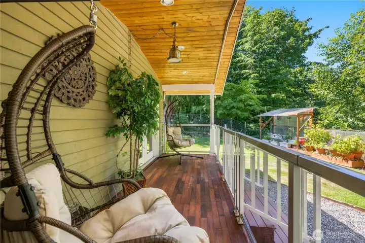 “Private rear deck with railing, offering views and sounds of the waterfall-fed koi pond.” “Private rear deck with railing, offering views and sounds of the waterfall-fed koi pond.”