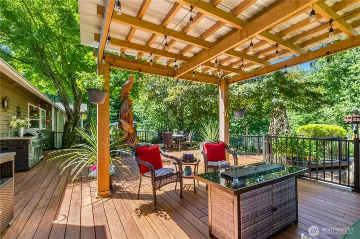 “Covered pergola provides a sheltered space to enjoy the deck in any weather.” “Covered pergola provides a sheltered space to enjoy the deck in any weather.”