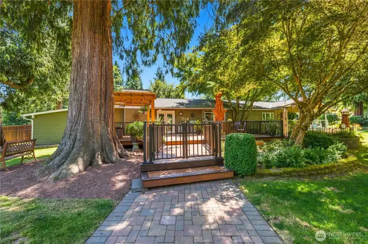 “Double-locking gates provide access to the beautifully landscaped yard and detached garage.” “Double-locking gates provide access to the beautifully landscaped yard and detached garage.”
